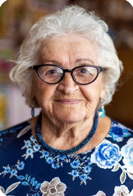 Portrait of a smiling older woman with white hair and glasses